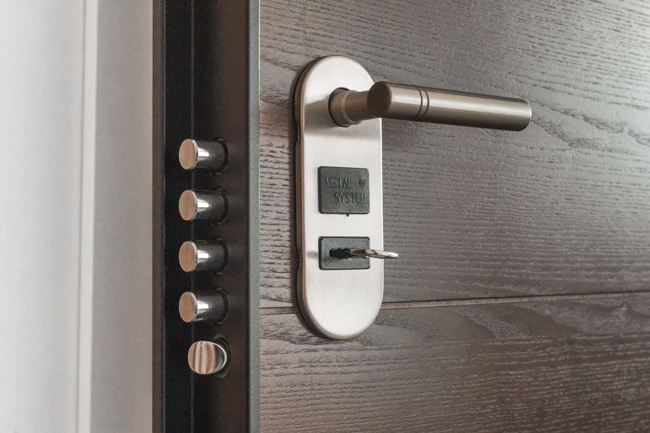 about-01 Metal door handle and lock system with key inserted, showcasing security features.