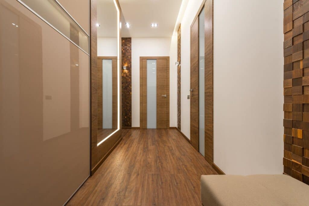 pexels-photo-7166935 Sleek and luxurious hallway featuring wooden elements, elegant lighting, and modern design.